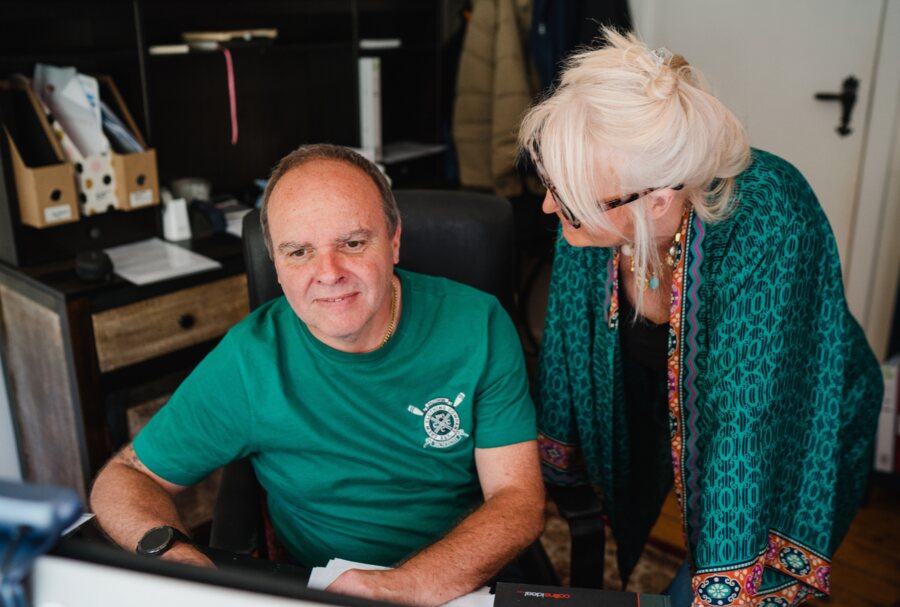 Jules and Lee Mitchell, founders of Mental Wealth Community CIC, working together at a desk